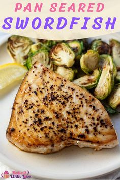 grilled fish with brussel sprouts and lemon wedges on a white plate