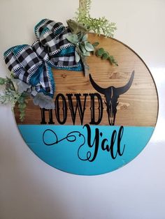 a wooden sign that says, howdy y'all with an steer on it