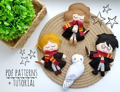 three felt harry potter dolls sitting on top of a mat