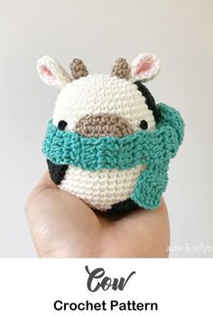 a crocheted animal that is in the palm of someone's hand with text overlay saying, cow crochet pattern