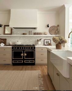 a kitchen with an oven, sink and counter tops in white marbled wood flooring