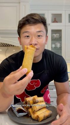 a man sitting at a table with food in front of him and the caption reads, these are my favorite spring rolls