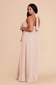 the back of a woman in a long dress