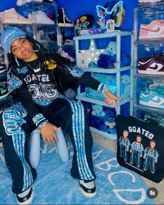 a woman sitting on top of a bed in a room filled with blue and white items