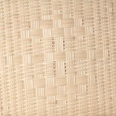 a close up view of the woven material on a tablecloth that is white and beige