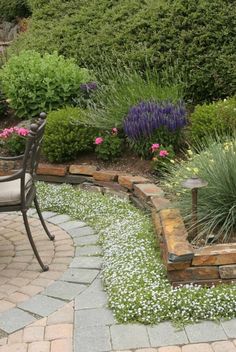 an outdoor patio with flowers and plants around it