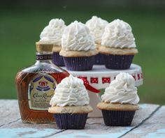 cupcakes with white frosting and a bottle of booze