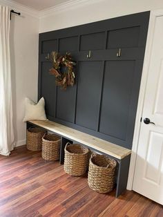 the entryway is decorated with black cabinets and baskets