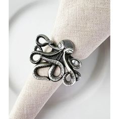 an octopus ring sitting on top of a white plate