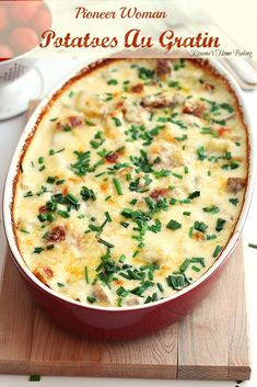 a casserole dish with cheese and spinach in it on a cutting board