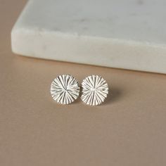 These minimalist geometric earrings feature a beautiful radiant sun pattern that has lovely detail and shimmer. The studs are a nice generous size at 12mm wide but are still comfortable and perfect for everyday wear. I've soldered sterling silver posts to the top backs of them and they're held securely in place with sterling silver backings. The celestial theme is always on trend and the textured surface gives these earrings a unique modern look that works with any outfit. You can find lots more Small Silver Stud Earrings, Silver Stud Earrings Simple, Minimalist Silver Earrings, Round Silver Earrings, Silver Minimalist Jewelry, Minimal Silver Jewelry, Sterling Silver Star Earrings, Simple Silver Earrings, Celestial Theme