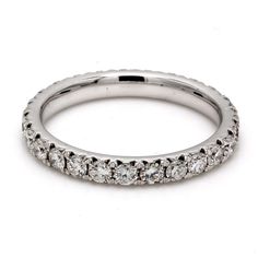 a white gold wedding band with round brilliant cut diamonds on the outside and inside sides