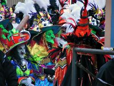 a group of people wearing colorful costumes and hats