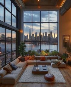 a living room filled with lots of furniture next to large windows and a view of the city