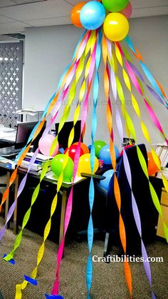 an office decorated with balloons and streamers