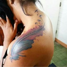 a woman with a feather tattoo on her back