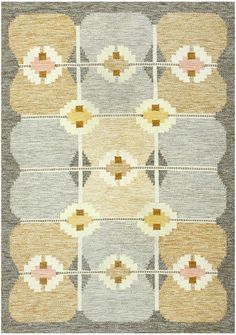 an area rug with different colors and patterns on it, including beiges, greys,