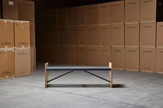 a ping pong table surrounded by cardboard boxes in an empty room with no people