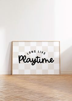 a white framed poster with the words long live, pray time on it in front of a wooden floor