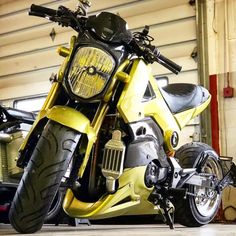 a yellow and black motorcycle parked in a garage