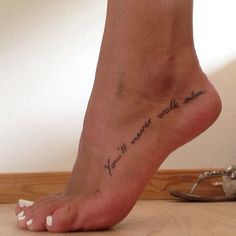 a woman's foot with the words you are my sunshine written on her left side