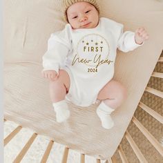 "Celebrate new years with this sweet piece featuring the text \"first new year\". This sweet piece is the perfect light layer for baby. The hues are neutral and printed on 100% cotton 7.2 oz. Please refer to the labeled picture (image 3)  for the apparel type. When you select your product from the drop down menu, a picture of that exact item you will be receiving will show on your screen. Sleeper Item (pajamas)  has optional mitten and footies that can be folded. The classic baby bodysuit comes in long and short sleeves. The romper is a sweatshirt material. This piece is a sturdy material, cozy soft and perfect for staying cuddly.  This product is handprinted using nontoxic, water-based inks on quality cotton. This item comes in the following infant sizes  newborn 0-3 months 3-6 months 6-1 My First New Years Onesie, Baby New Years Outfit, Newyears Outfits, Outfit New Year, New Year Outfit, New Years Look, Monthly Baby Photos, Monthly Baby