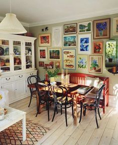 a dining room with pictures on the wall