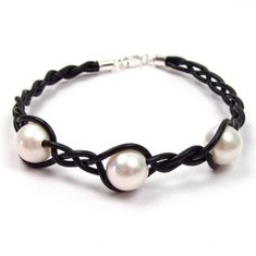 Beautiful and elegant genuine fine quality cultured fresh water white pearl braided leather cord bracelet    Pearls: 3 fine quality genuine cultured fresh water white pearls    Pearl measurement: approx. 8.5-9mm in diameter    Pearl shape: round to slightly off round    Luster: high    Color: white with possible slight pink or cream overtones    Surface: some minor surface clouds    Cord type: genuine black leather at 1.5mm in thickness    Clasp: 925 sterling silver lobster clasp    Bracelet mea Elegant Braided Leather Bracelets, Elegant Adjustable Braided Jewelry, Elegant Round Adjustable Leather Bracelet, Elegant Braided Leather Bracelet, Elegant Round Leather Jewelry, Elegant White Leather Jewelry, Bracelet Pearls, Pearl Birthstone, Leather Cord Bracelets