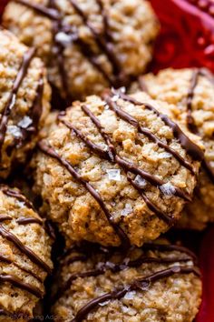 cookies with chocolate drizzled on top in a red basket, ready to be eaten