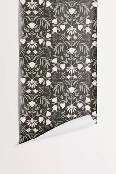 a black and white flowered pattern on a piece of paper that is folded in half