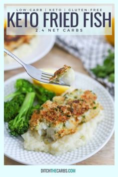 a white plate topped with fish and broccoli next to a lemon wedge on top of mashed potatoes