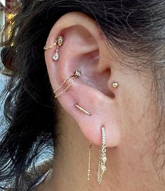 a close up of a person's ear with three different types of piercings