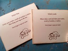 two wedding cards with elephants on them sitting next to each other, one has an elephant and the other has a heart