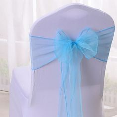 the back of a white chair with a blue bow on it's sasher