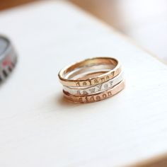 Mother's Day Gift | Personalized stackable ring, handstamped with a name, date, or special word. You may select the metal that you would like from the drop down menu.  The letters on this ring are left undarkened, and will not be perfectly aligned, as they are stamped and not engraved.  Metal: 14k gold filled, 14k rose gold filled, or .999 fine silver Dimensions: 2mm tall on average, but our rings are handmade so variations will occur. Font: lowercase typewriter Unsure what size you need? We hig Personalized Stackable Rings, Mothers Rings, Stackable Name Rings, Rings Rose Gold, Ring Stacks, Mothers Ring, Hand Stamped Ring, Diamond Initial Necklace, Name Ring