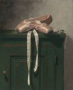 a painting of a pair of ballet shoes on top of a green cabinet with white ribbon