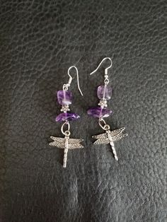 Dragonfly dangle earrings, with a dragonfly silver tone charm, Amethyst beads, purple beads, and a silver flower bead. Hung on a silver ear wire. Light weight and nice movement. A Dragonfly lovers gift. * Dragon fly charm * Silver flower * Purple glass beads * Amethyst beads * Silver ear wire Purple Dangle Beaded Earrings Wire Wrapped, Purple Wire Wrapped Beaded Dangle Earrings, Purple Wire Wrapped Dangle Beaded Earrings, Adjustable Wire Wrapped Purple Beaded Earrings, Adjustable Purple Wire Wrapped Beaded Earrings, Purple Hypoallergenic Dangle Crystal Earrings, Nickel-free Purple Sterling Silver Beaded Earrings, Purple Sterling Silver Beaded Dangle Earrings, Purple Metal Dangle Crystal Earrings