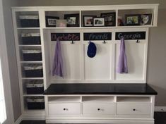 the entryway is decorated in white and black with lots of storage space for personal items