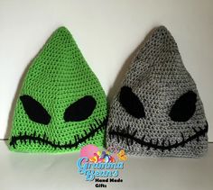 two crocheted hats with black eyes and green faces are shown in front of a white wall