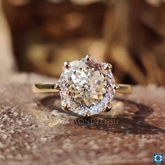 a diamond ring sitting on top of a wooden table