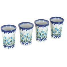 four blue and white glasses with flowers on them