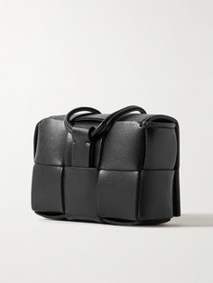 Bottega Veneta's case is a practical yet elevated way to keep your AirPods Pro secure and easily accessible. It's constructed from supple leather using the signature intrecciato weave and comes with a lanyard strap and a silver keyring etched with the brand's moniker. Functional Leather Bags With Card Slots, Modern Rectangular Cases With Card Slots, Modern Leather Wallet In Rectangular Case, Modern Leather Rectangular Cases, Textured Leather Rectangular Wallet, Rectangular Textured Leather Wallet, Modern Leather Protective Case, Functional Leather Rectangular Wallet, Modern Textured Leather Rectangular Wallet