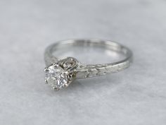 a white gold engagement ring with a diamond