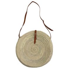 Round basket bag with long shoulder strap and leather closure, the shoulder strap is adjustable. A wonderfully simple shoulder bag and crossbody bag, hand-woven from dried palm leaves in a small family business. Hand-tanned leather from the streets of Marrakech. Dimensions are approximate, as they are handmade: Diameter: approx. 40 cm Depth (widest point): approx. 11 cm Adjustment of carrying strap (carrying height) in the middle of the bag: 36 cm-44 cm Origin: Handmade in Morocco Natural Woven Leather Crossbody Straw Bag, Natural Color Bucket Bag With Adjustable Strap For Market, Natural Bucket Bag With Adjustable Strap For Market, Natural Straw Bag With Leather Handles Crossbody, Natural Straw Crossbody Bag With Leather Handles, Natural Woven Leather Crossbody Shoulder Bag, Natural Straw Crossbody Bag With Adjustable Strap, Natural Palm Leaf Shoulder Bag For Market, Palm Leaf Basket Shoulder Bag With Leather Handles