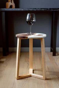 a wine glass sitting on top of a wooden table