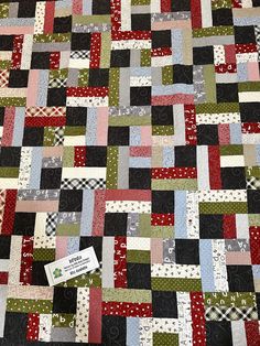 a patchwork quilt is shown with a tag on it