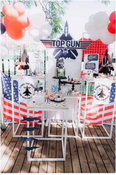 a table with american flags and balloons on it