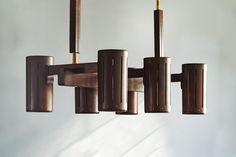 a chandelier made out of wood and metal tubes