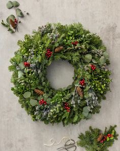 a christmas wreath and scissors on a table