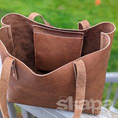 Long awaited, and perfect for the ren faire or the grocery store- we present our Customizable Tote Bag. Beautiful oil tan leather will age gloriously, and the stitching reinforced by copper burr rivets is sure to stand the test of time. The Medium is approx. 10.5" tall, 12" wide, and 6" deep The Large is approx. 12" tall, 14" wide, and 6" deep There are a slew of other options you can add or skip, to make it perfect for your needs. If you have questions about leather colors, availability, etc. P Rustic Bags With Leather Handles For Everyday, Rustic Bags With Leather Handles For Daily Use, Rustic Everyday Tote Bag, Rustic Tote Bag For Everyday Use, Rustic Everyday Use Tote Bag, Rustic Brown Bags With Leather Handles, Rustic Brown Leather Bag, Rustic Everyday Bags With Leather Lining, Brown Waxed Finish Tote Shoulder Bag